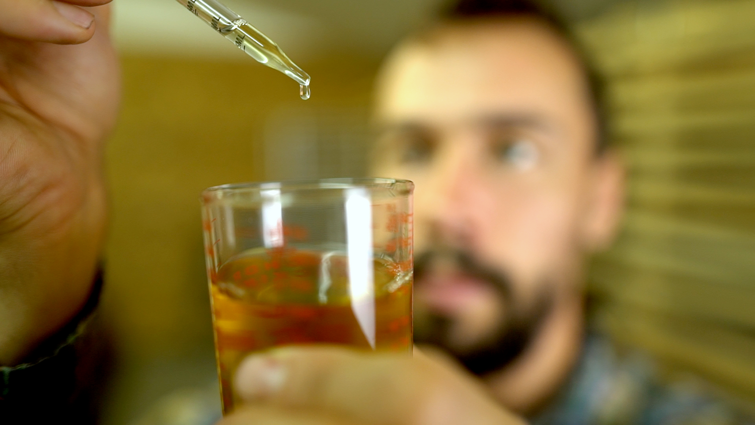 Man visually testing pine pollen tincture
